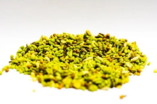 Vibrant pile of fennel seeds and mixed spices on a bright background, perfect for culinary themes.